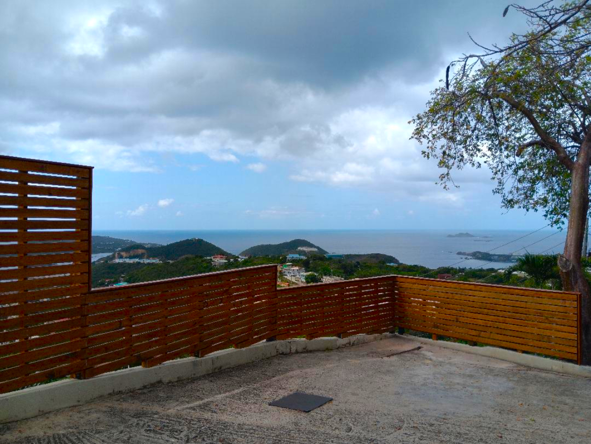 Hillside terrace with custom slatted privacy screen and ocean view